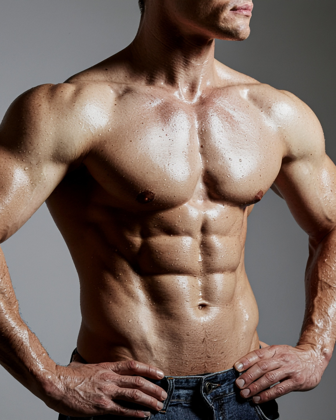 Shirtless muscular man with his hands on his hips wearing jeans